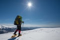 Hiker snowshoeing in winter mountains during sunny day Royalty Free Stock Photo