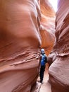 Hiker in Spooky Gulch slot canyon, at Dry Fork, a branch of Coyote Gulch, Grand Staircase Escalante National Monument