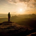 Hiker stand on the sharp corner of sandstone rock in rock empires park and watching over the misty and foggy morning valley to Sun Royalty Free Stock Photo