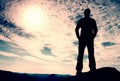 Hiker stand on the sharp corner of sandstone rock in rock empires park and watching over the misty and foggy morning valley to Sun