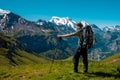 Hiker standing on the Bernese Oberland hiking ridge with mountain landscape in Switzerland