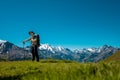 Hiker standing on the Bernese Oberland hiking ridge with mountain landscape in Switzerland