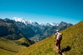 Hiker standing on the Bernese Oberland hiking ridge with mountain landscape in Switzerland