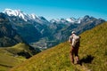 Hiker standing on the Bernese Oberland hiking ridge with mountain landscape in Switzerland