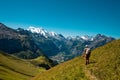 Hiker standing on the Bernese Oberland hiking ridge with mountain landscape in Switzerland