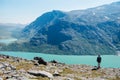 hiker standing on Besseggen ridge and looking at Gjende lake in Jotunheimen National Park