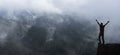 Hiker standing on a cliffs edge. The top of the mountain.