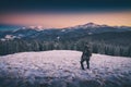 Hiker standing on a hill with snow. Instagram stylization Royalty Free Stock Photo