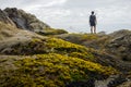 A hiker is standing and looking out to sea stack. Royalty Free Stock Photo