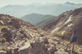 Hiker standing on rocky mountain footpath