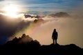 Hiker standing on the sharp corner of the sandstone observing  scenic sunset over the forest, Poland Royalty Free Stock Photo