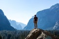 Hiker Standing On Top of Mountain Looking out at Vast Yosemite National Park