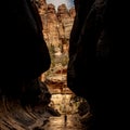 Hiker Stands In The Creek Below The Giant Walls Of The Subway