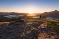 Hiker staring at the beauty of the sun rising star over Lake Wanaka in New Zealand during golden hour time Royalty Free Stock Photo