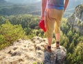 Hiker stays on a rocky ridge and enjoy view over long valley