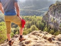 Hiker stays on a rocky ridge and enjoy view over long valley