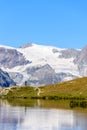 Hiker at Stellisee - beautiful lake with reflection of Matterhorn - Zermatt, Switzerland