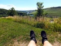 Hiker taking a rest near river Mosel on hiking-trail Moselsteig Royalty Free Stock Photo