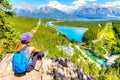 Staycation hiker on top of mountain overlooking local town of Canmore and Kananaskis