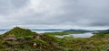 Hiker on top of a mountain overlooking Loch Leathan, Isle of Skye Royalty Free Stock Photo