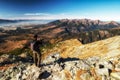 Hiker at top of the peak making picture of beautiful mountain landscape in Slovakia Royalty Free Stock Photo