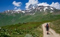 Hiker on trail to Koruldi Lakes in Caucasus Mountains of Georgia near Mestia Royalty Free Stock Photo