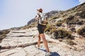 Hiker traveler girl on a hiking trail, travel and active lifestyle concept