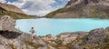 Traveler standing at beautiful azure mountain lake