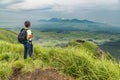 Hiker trekking to the hill top and watching mount Aso volcano in Royalty Free Stock Photo