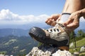 Hiker tying boot laces, high in the mountains Royalty Free Stock Photo