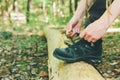 Hiker tying boot laces on a log Royalty Free Stock Photo