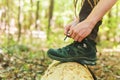 Hiker tying boot laces on a log Royalty Free Stock Photo