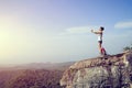 Hiker use digital tablet taking photo at mountain peak cliff Royalty Free Stock Photo