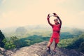 Hiker use smartphone taking self photo on seaside mountain top Royalty Free Stock Photo