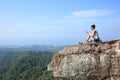 Hiker using digital tablet at mountain peak