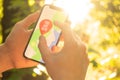 Hiker is using mobile phone for navigation in the forest Royalty Free Stock Photo