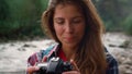 Hiker using photo camera during hike. Photographer looking pictures on camera Royalty Free Stock Photo