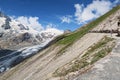 hiker walking along a path at Grossglockner Mountain and Pasterze in Austria. Summer. Royalty Free Stock Photo