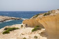 Hiker walking along an uplifted wave-cut notch Royalty Free Stock Photo