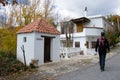 Hiker walking down a street in the Alpujarra next to a hermitage that has a sign that says hermitage of blessed souls