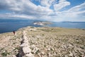 Hiker in the moonlike landscape near Baska, island of Krk, Croatia