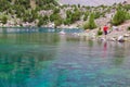 Hiker Walking on Footpath beside Shore Azure Mountain Lake Royalty Free Stock Photo