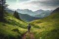 Hiker walking on a green meadow trail against the backdrop of a breathtaking mountain landscape. The image conveys a sense of