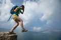 hiker walking off of a cliff with the eyes covered