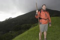 Hiker With Walking Stick On Hillside