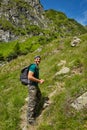 Hiker walking to the mountain peak Royalty Free Stock Photo