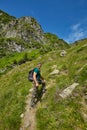 Hiker walking to the mountain peak Royalty Free Stock Photo