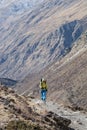 Hiker walking on the trail in Nepal, on Annapurna Circuit