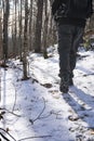 Hiker walks on icy snow in microspikes