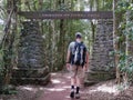 Hiker walks under a sign at lamington national park in queensland